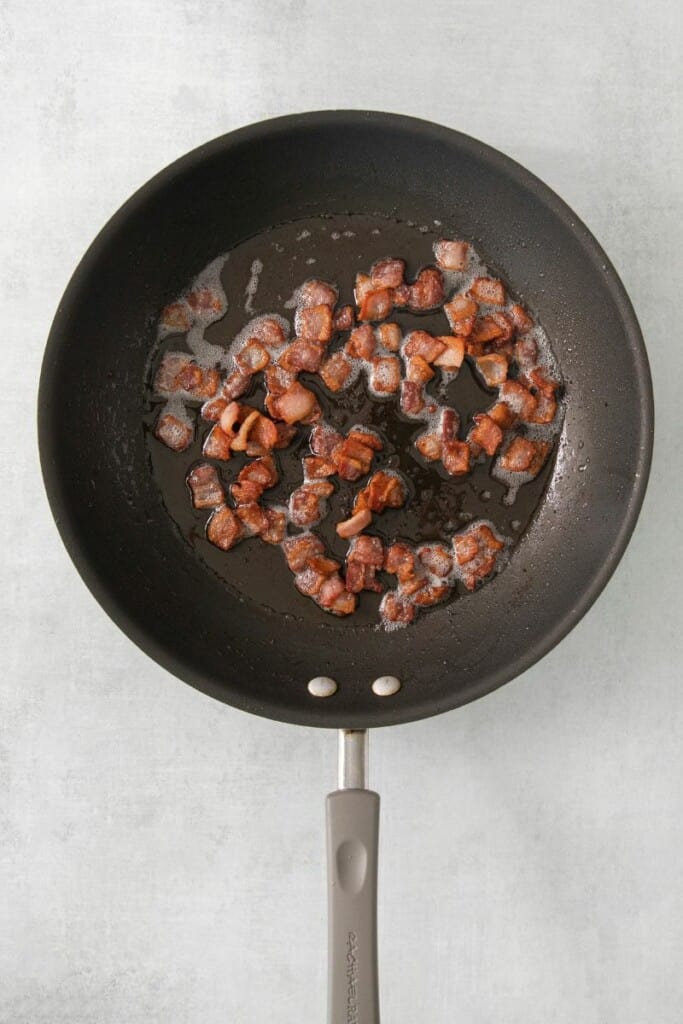 Diced bacon sauteed in a small skillet.