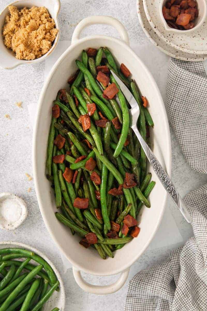 Green Beans with Bacon in an oblong serving dish with a fork.