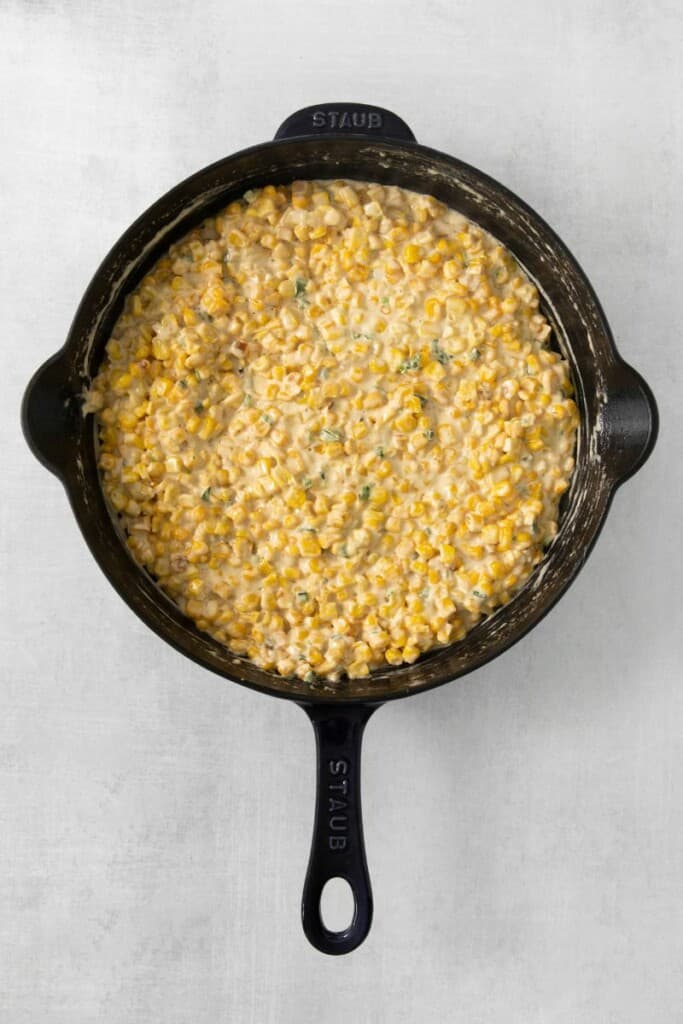 Corn and cream in a cast iron skillet.