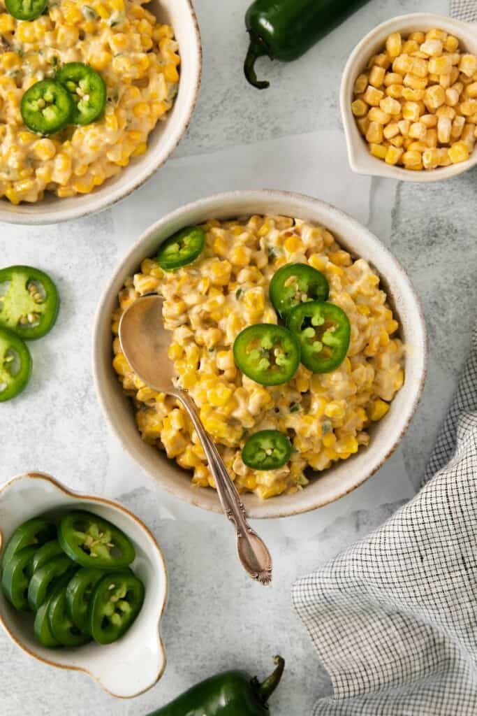 A spoon in a bowl of jalapeno cream corn.