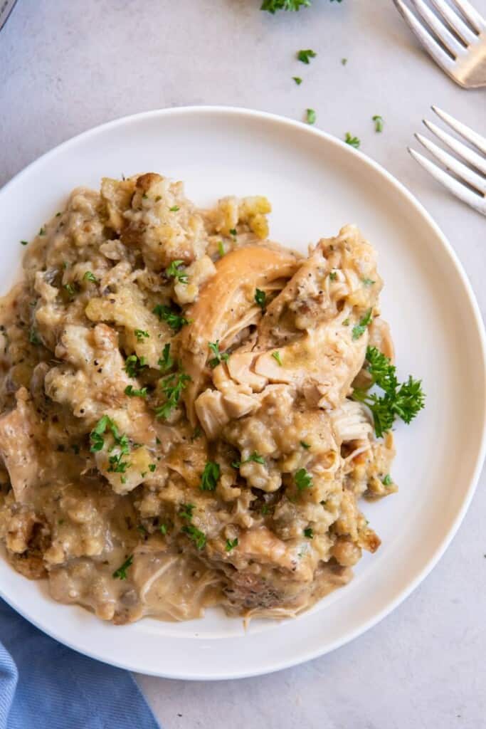 Chicken and stuffing on an off white plate.