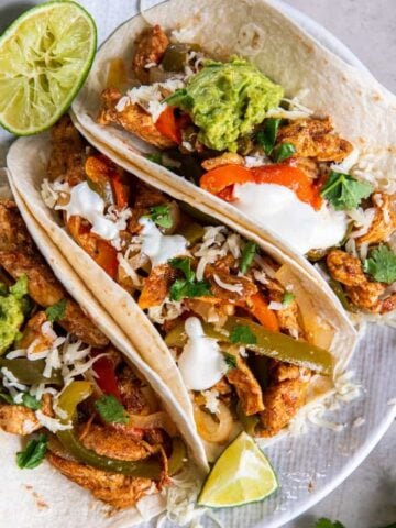 3 Chicken Fajitas on a white plate.