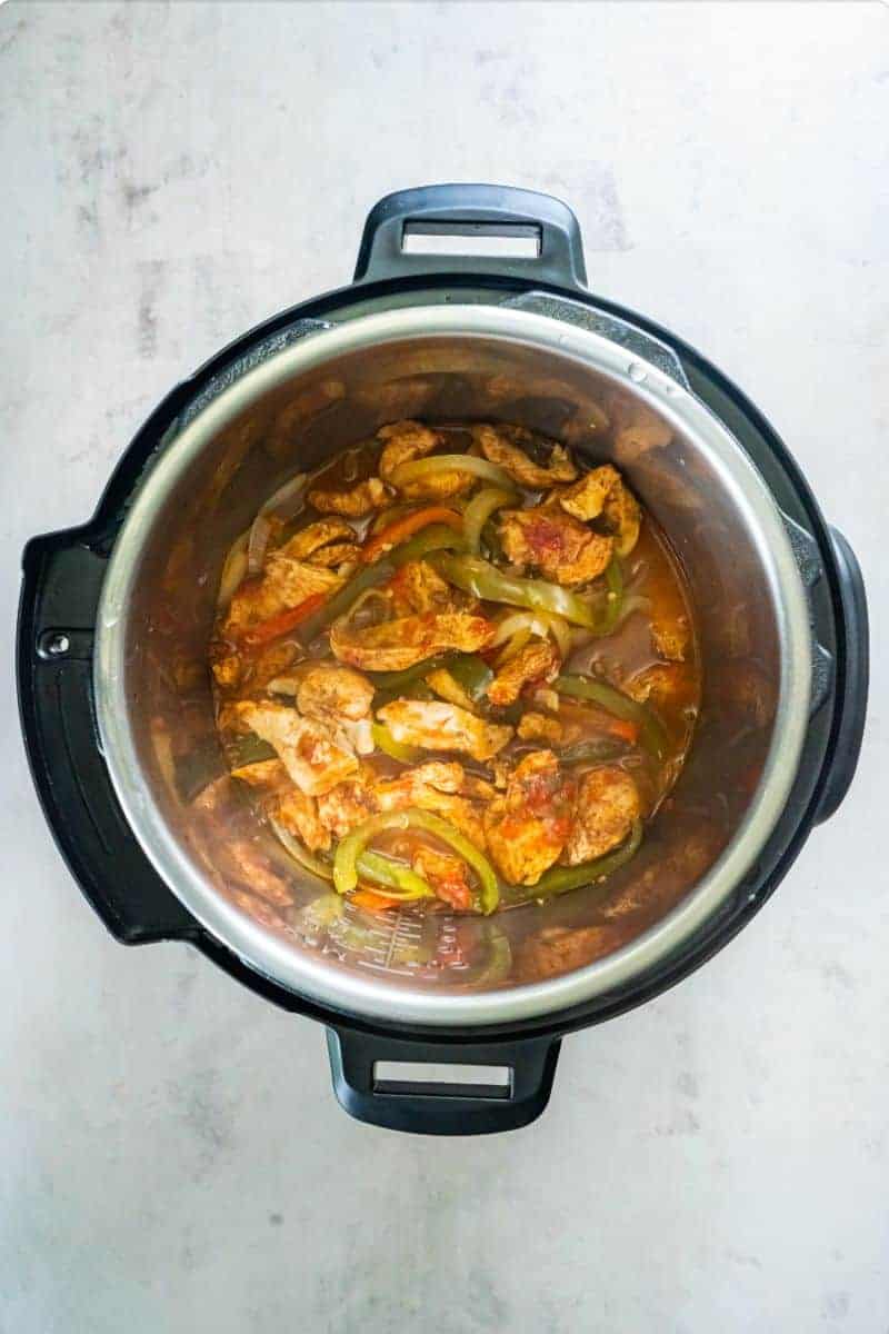 Seasoned chicken, salsa, onions and peppers cooked in an Instant Pot.