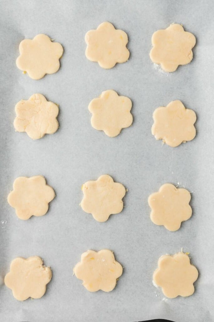 Cut out cookies placed on a parchment lined cookie sheet.
