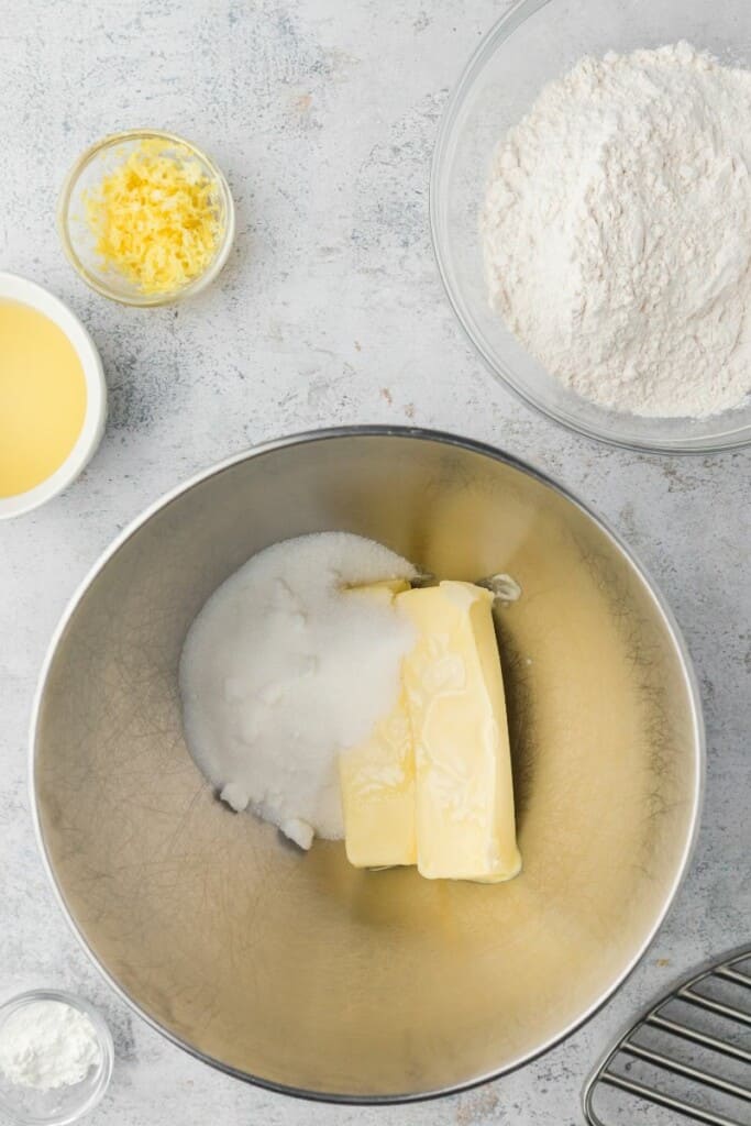 Combining butter and sugar in a mixing bowl.