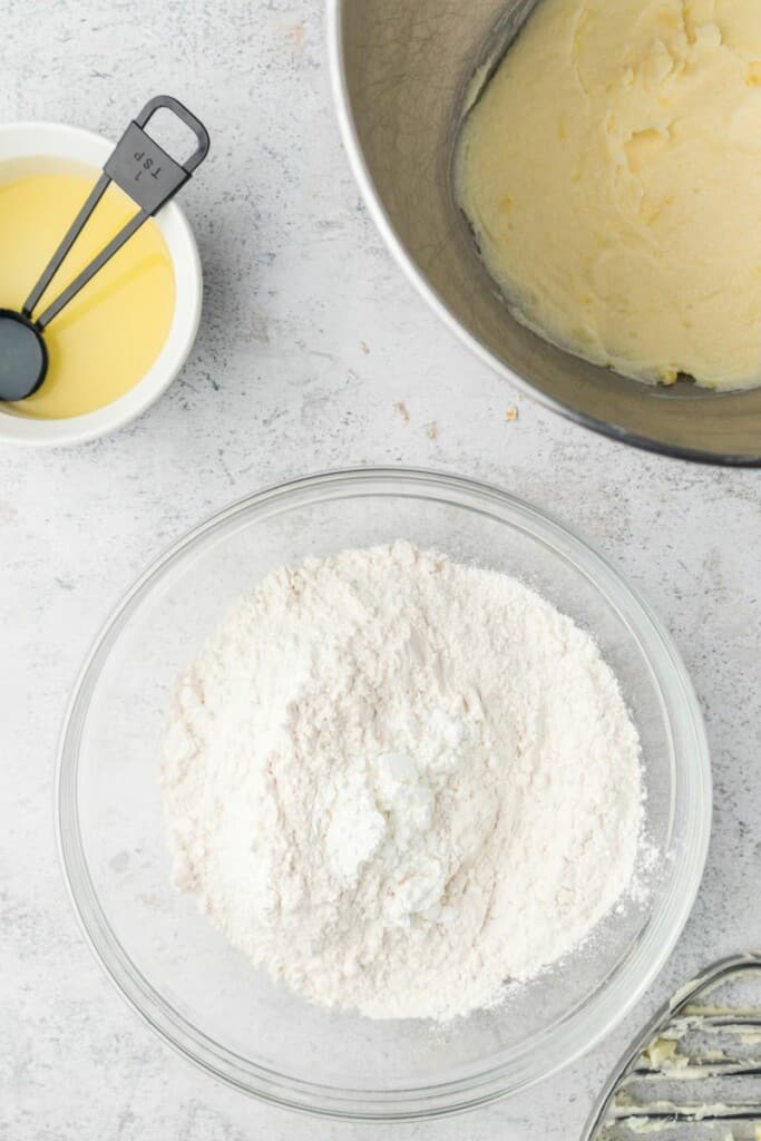 Combining flour and cornstarch in a small clear bowl.