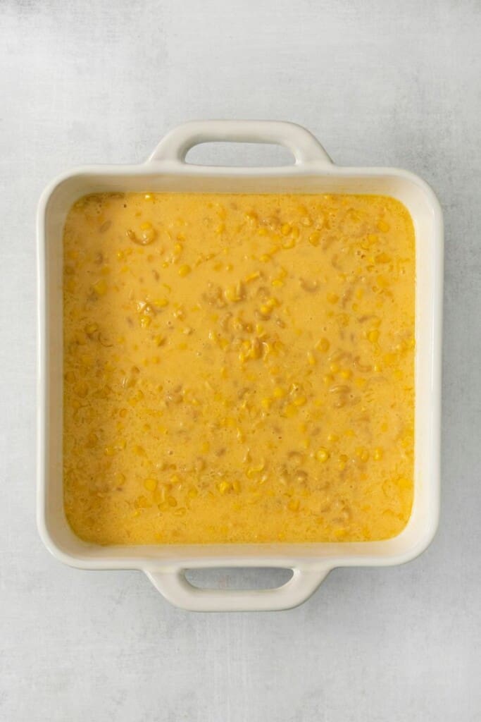 Corn macaroni casserole mixture in a square casserole baking dish.