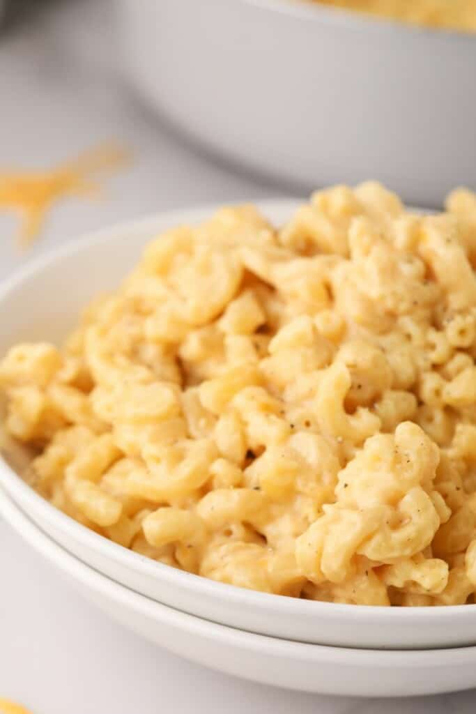Zoomed in view of macaroni and cheese in a white bowl.