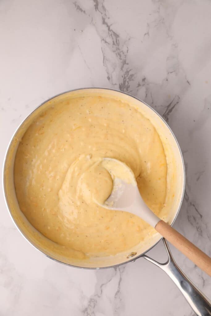 A cheesy roux in a saucepan, ready to mix with macaroni.