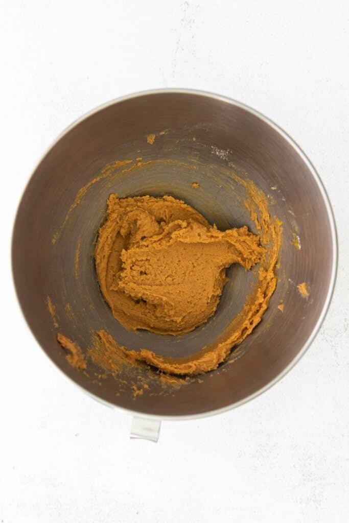 Cookie batter to make peanut butter blossoms in a mixing bowl.