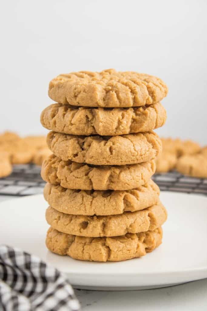 A vertical stack of seven peanut butter cookies.