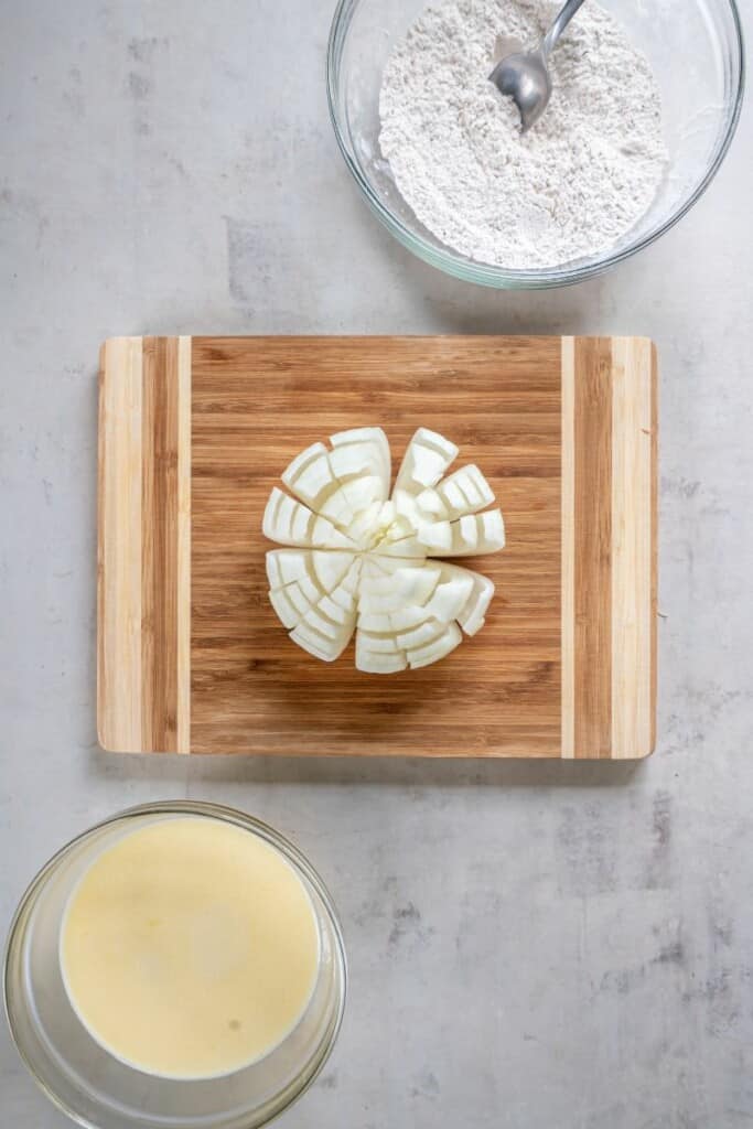 Separating the layers of an onion for a blooming onion.