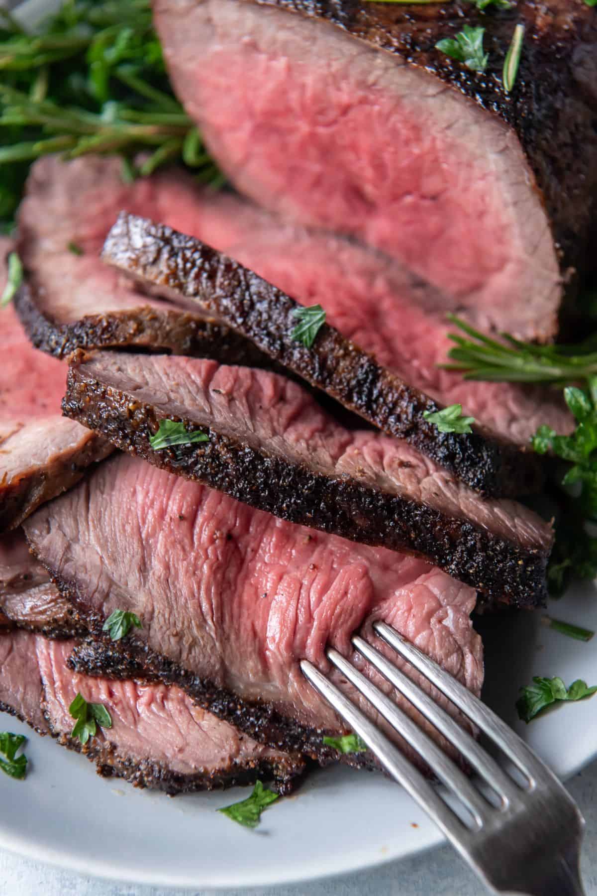 Close up of the air fryer roast beef slices to show the perfectly cooked inside.