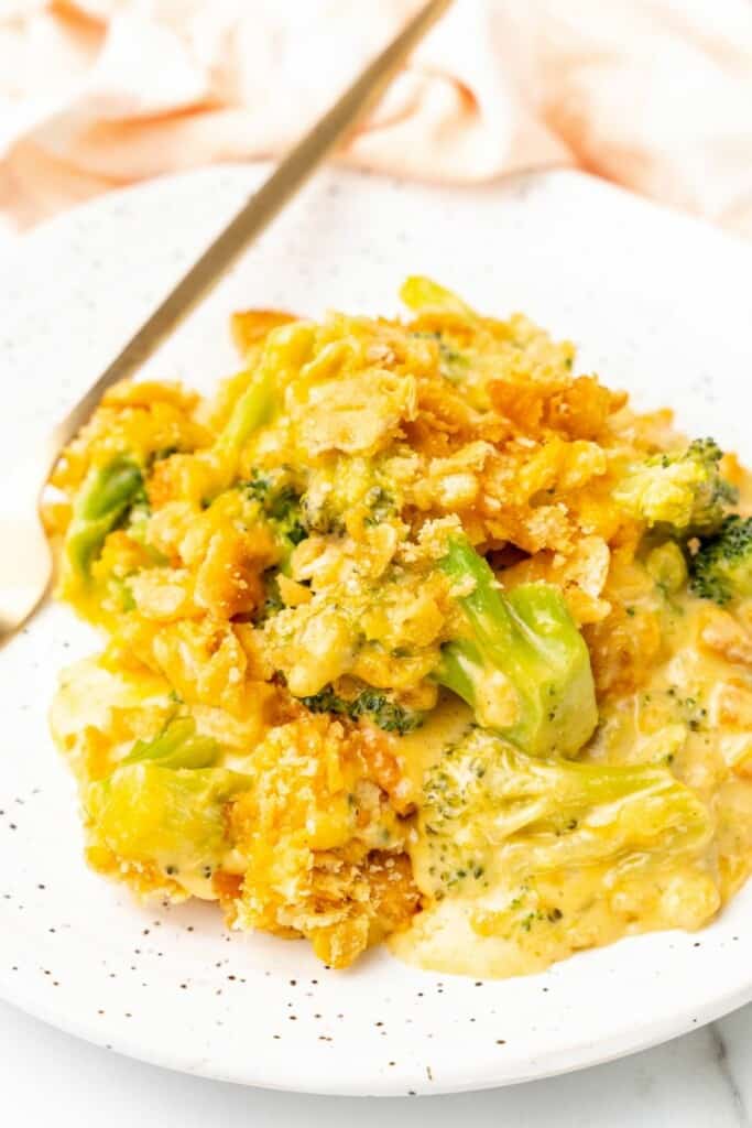 A serving of broccoli casserole on a white plate.