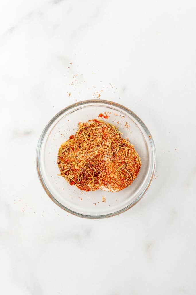 Seasonings for pork tenderloin combined in a small clear bowl.