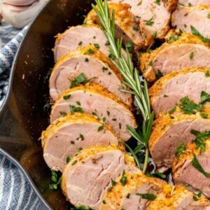 Slices of pork tenderloin prepared in a cast iron skillet.