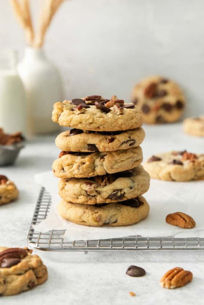 A vertical stack of five pecan chocolate chip cookies.