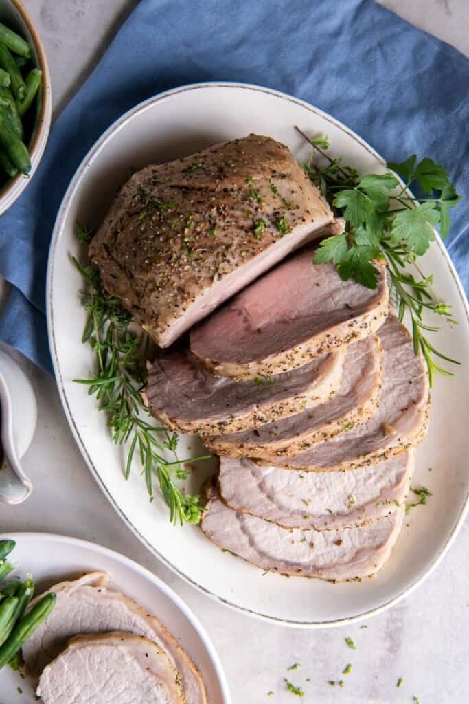 Overhead view of pork loin cut into slices.