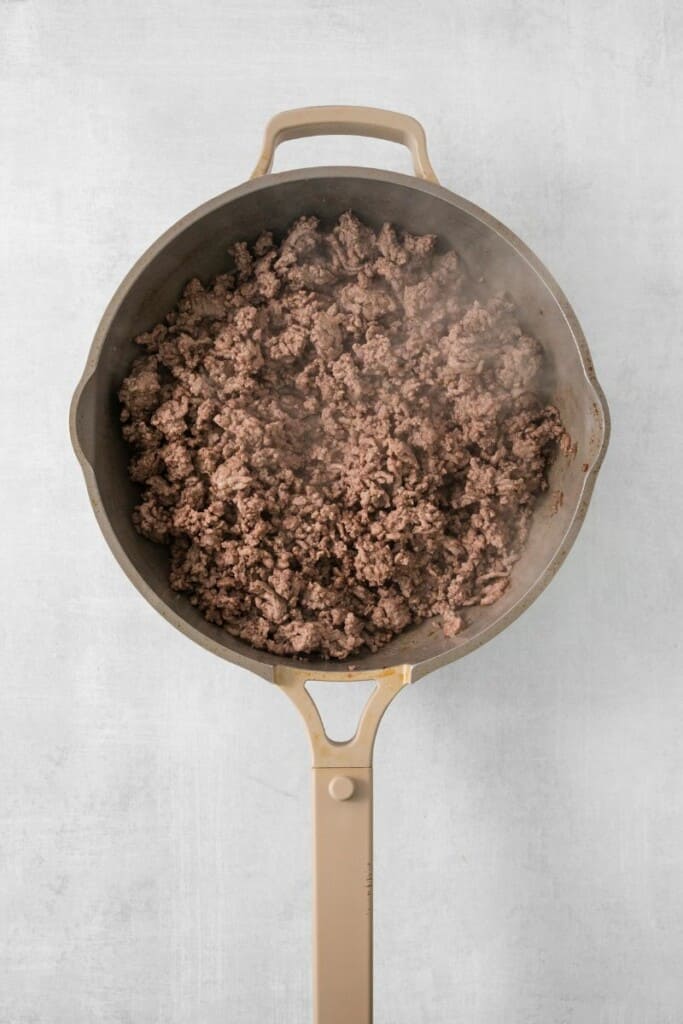 Browning ground beef in a skillet.