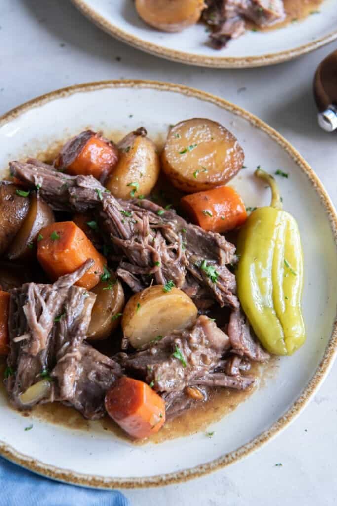 A close up view of prepared and plated Mississippi Pot Roast with Vegetables.