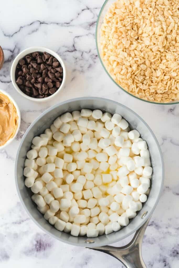 Adding marshmallows to small saucepan to melt with the butter.