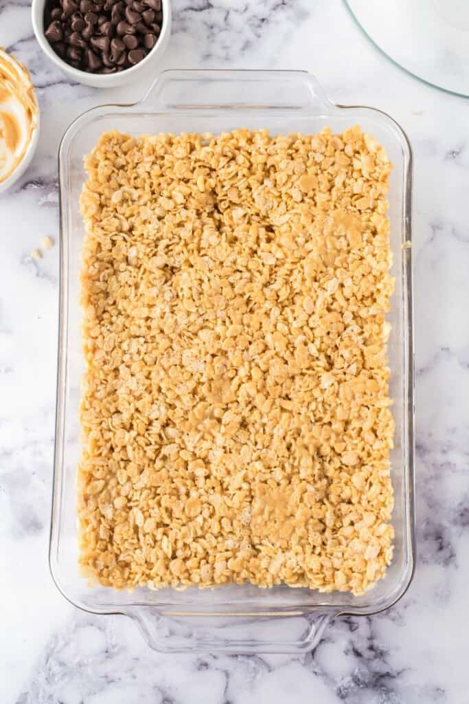 Rice Krispie mixture poured into a clear baking dish.