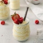 A serving bowl of vanilla mousse topped with fresh berries.
