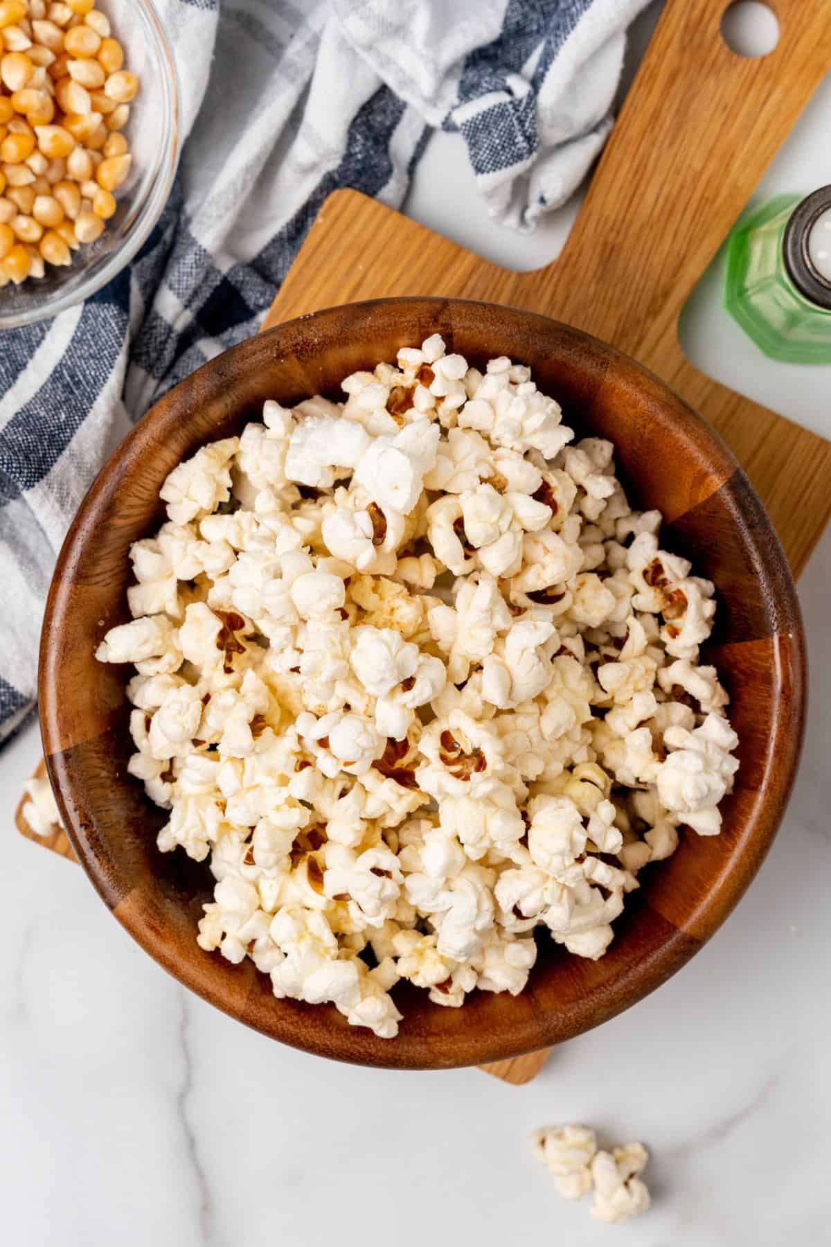 Air fryer popcorn in a wooden serving bowl.