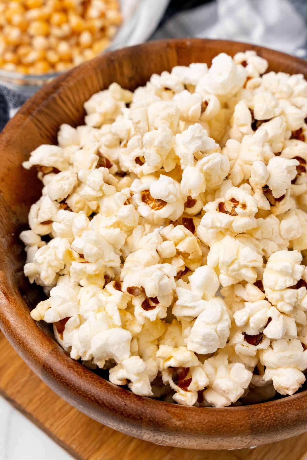 Closeup of the air fryer popcorn in a wooden serving bowl.