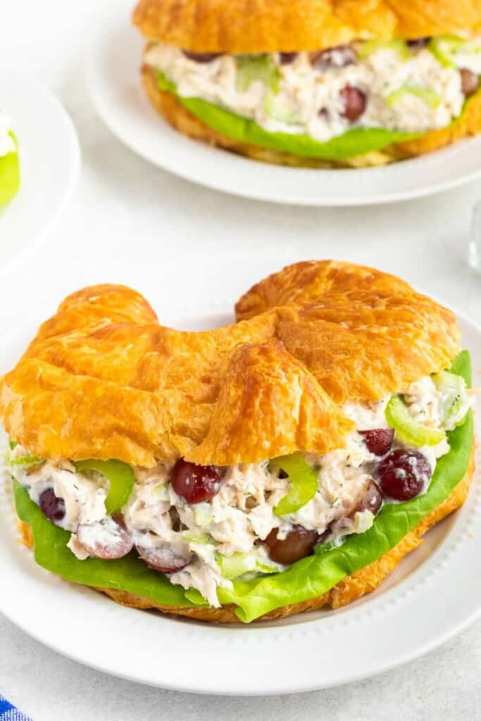 Close up view of chicken salad in a croissant.