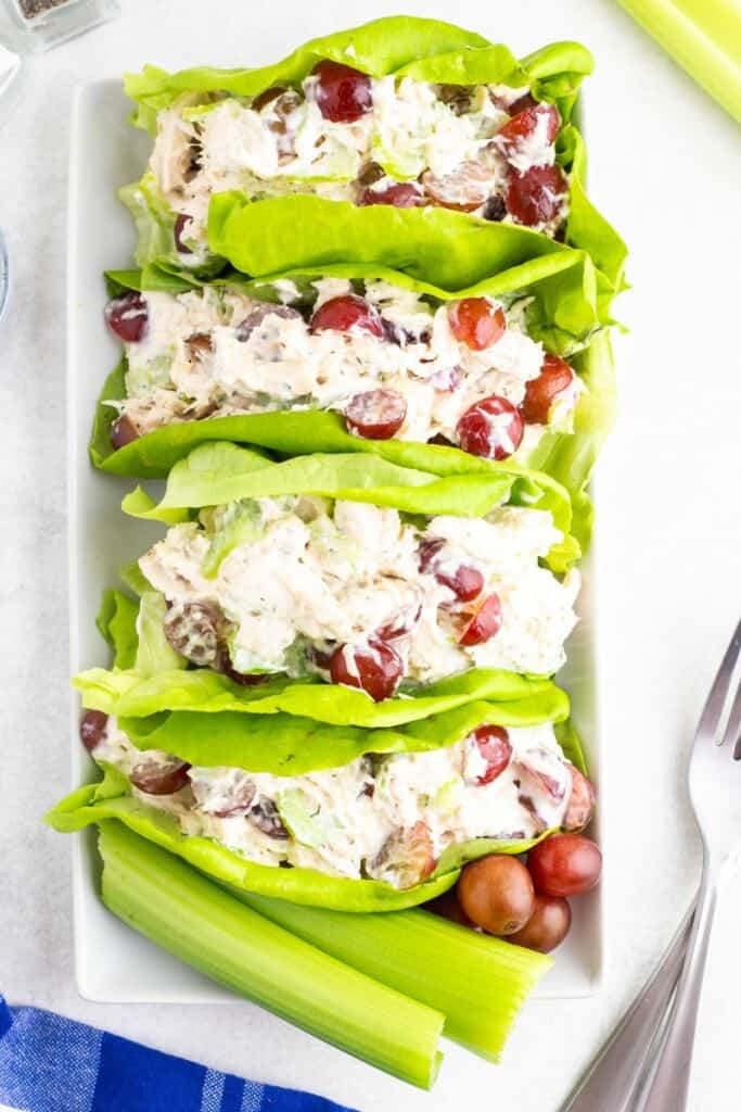 Four Chicken Salad Lettuce Wraps on a serving platter with celery.