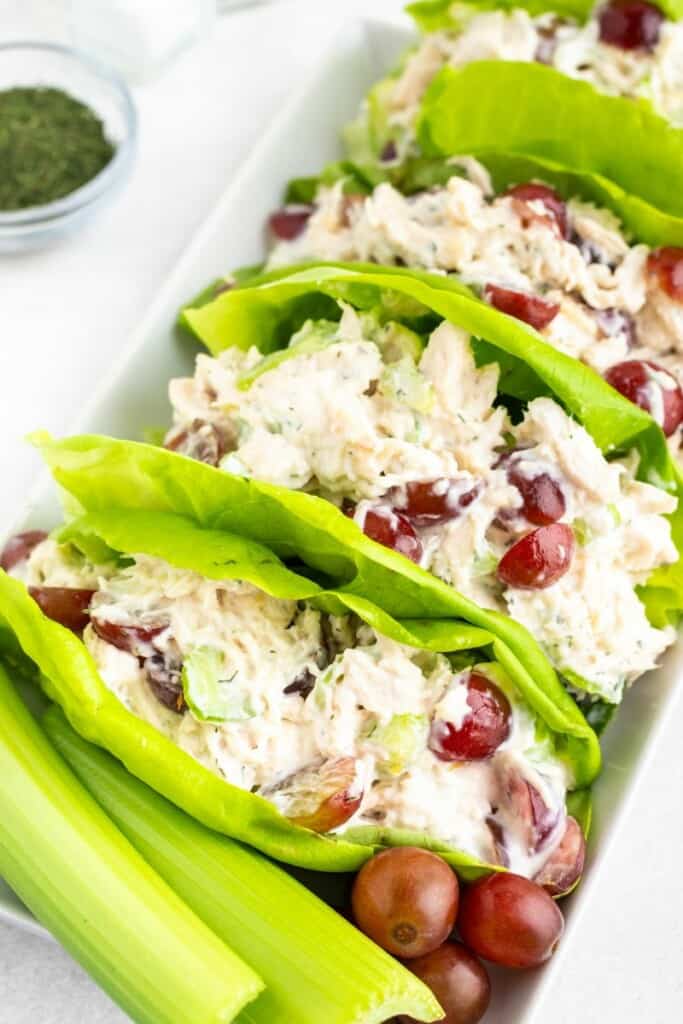 Chicken salad being served in lettuce as wraps.