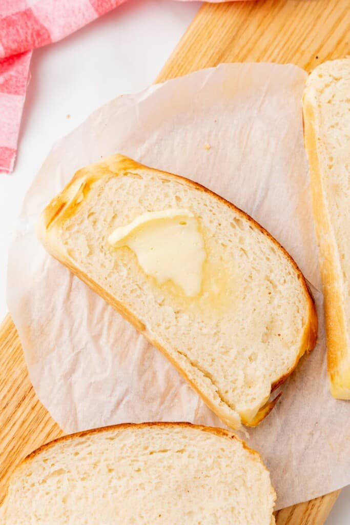 A slice of homemade bread with a pat of butter.