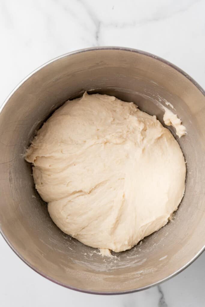Homemade bread dough ingredients fully combined in a mixing bowl.
