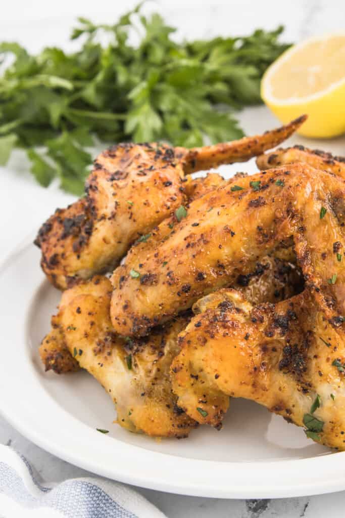 A plate of prepared whole chicken wings.