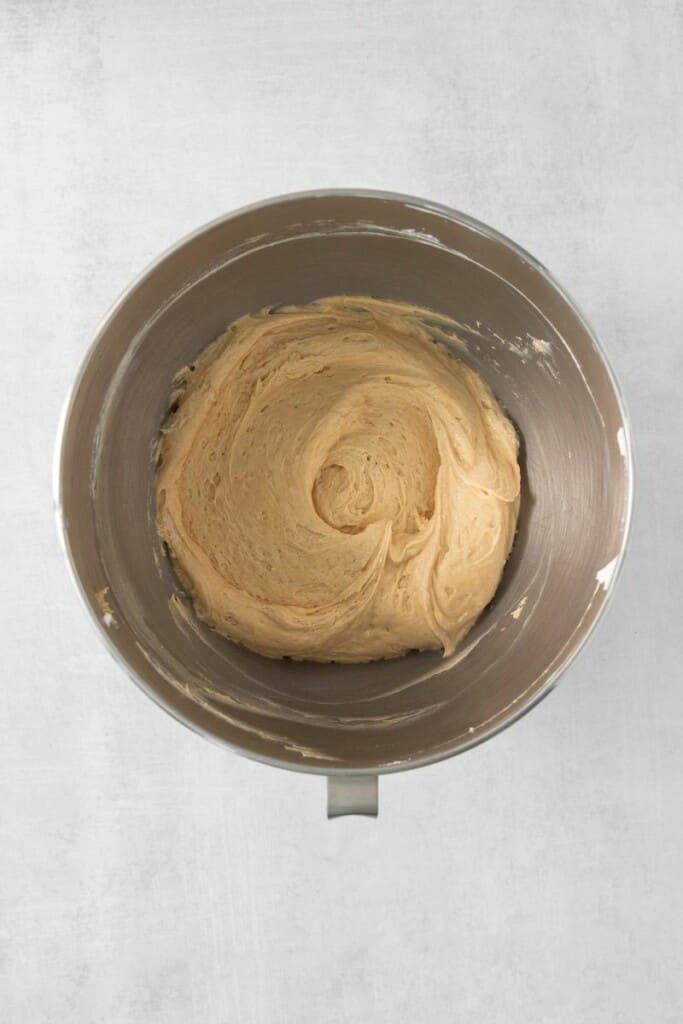 Folding in remainder of cool whip to peanut butter cream cheese mixture in a mixing bowl.