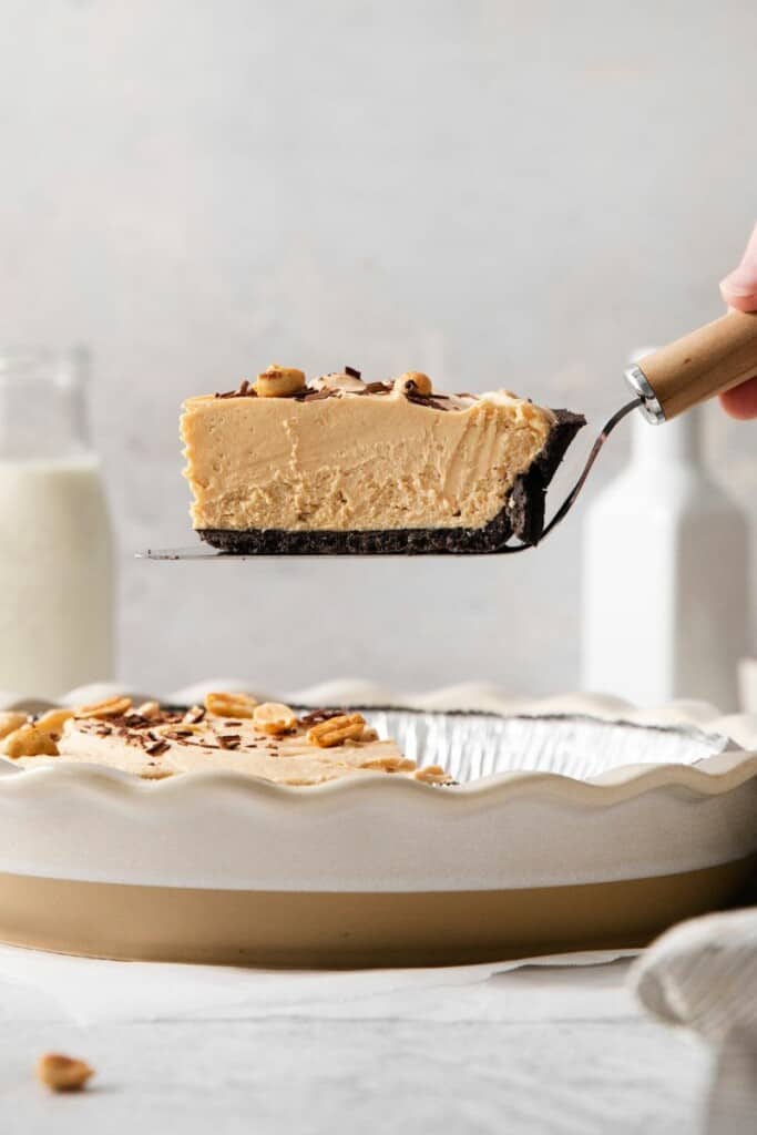 One slice of peanut butter pie being lifted from the pie dish.