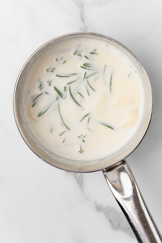 Combined Cream, butter, garlic, rosemary and thyme in a saucepot.