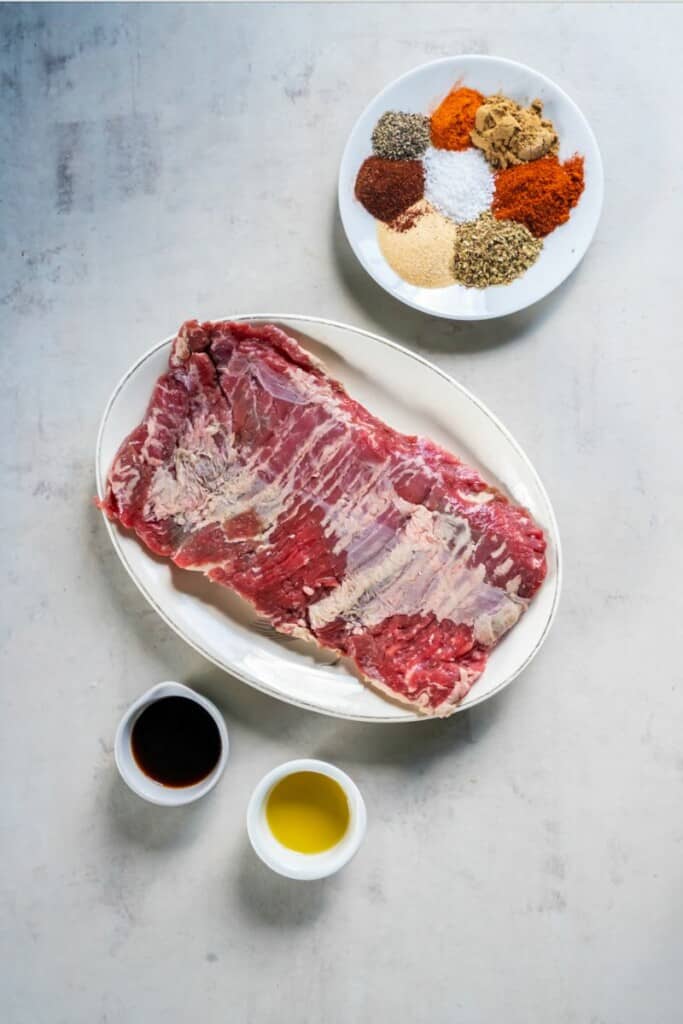 Ingredients needed to prepare skirt steak in a crock pot.