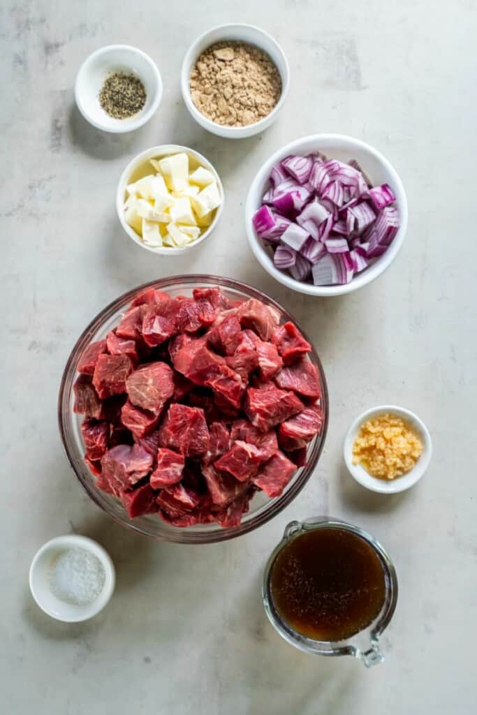 Ingredients needed to prepare steak cubes in a crock pot.