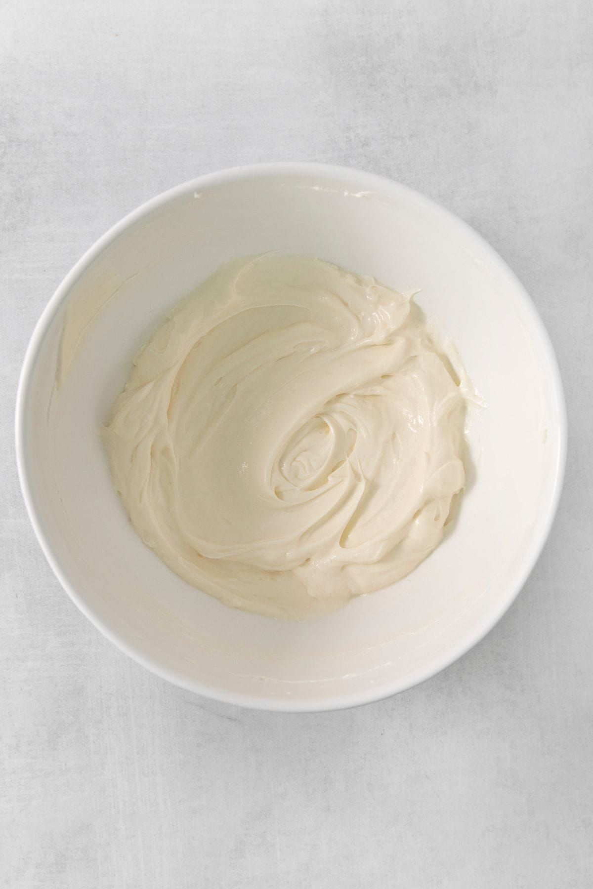 The cream cheese, marshmallow fluff, and vanilla all mixed in a mixing bowl.