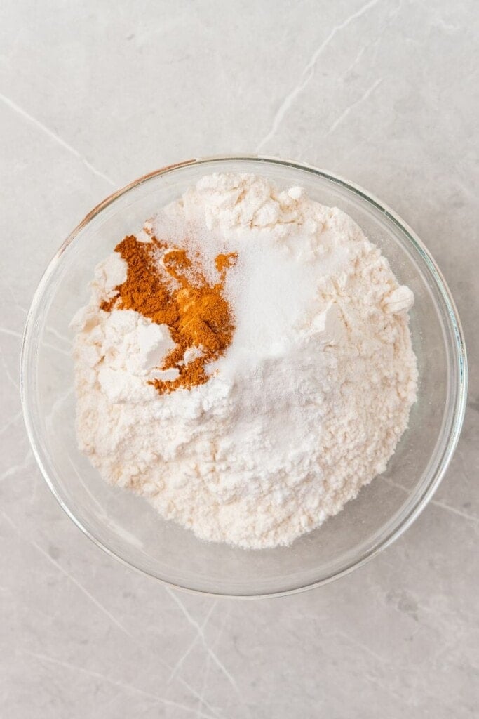 Combining flour, cinnamon, baking soda and salt in a mixing bowl.