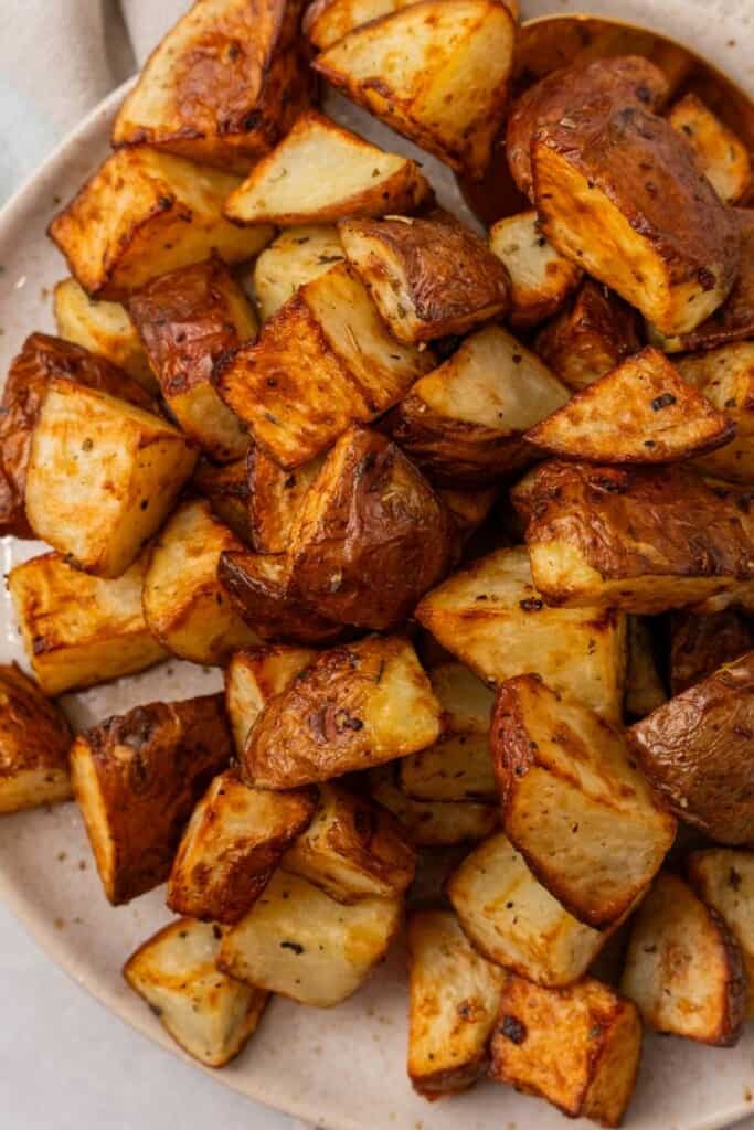 A close up view of seasoned red potatoes on a serving platter.