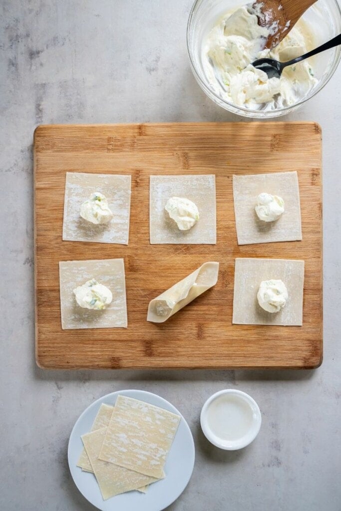 making homemade wontons with filling