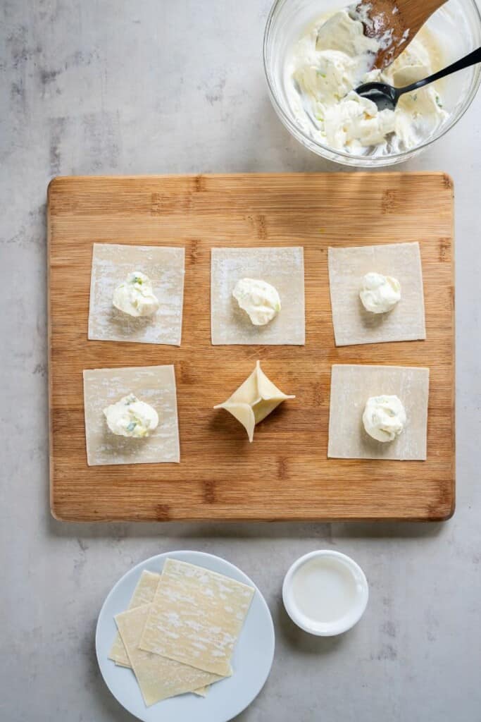 step by step process of how to fill and properly close a cream cheese wonton