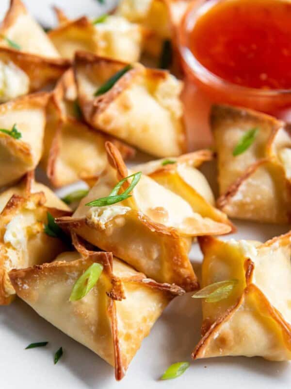 air fried wontons on a plate with dipping sauce