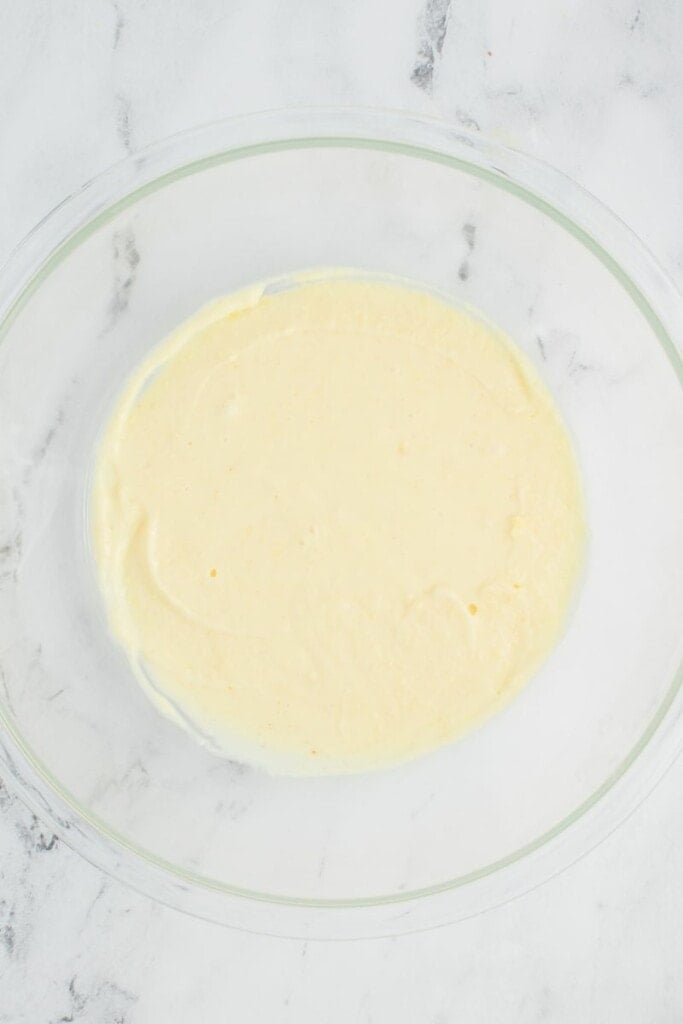 mixing instant vanilla pudding with cold milk in a bowl.