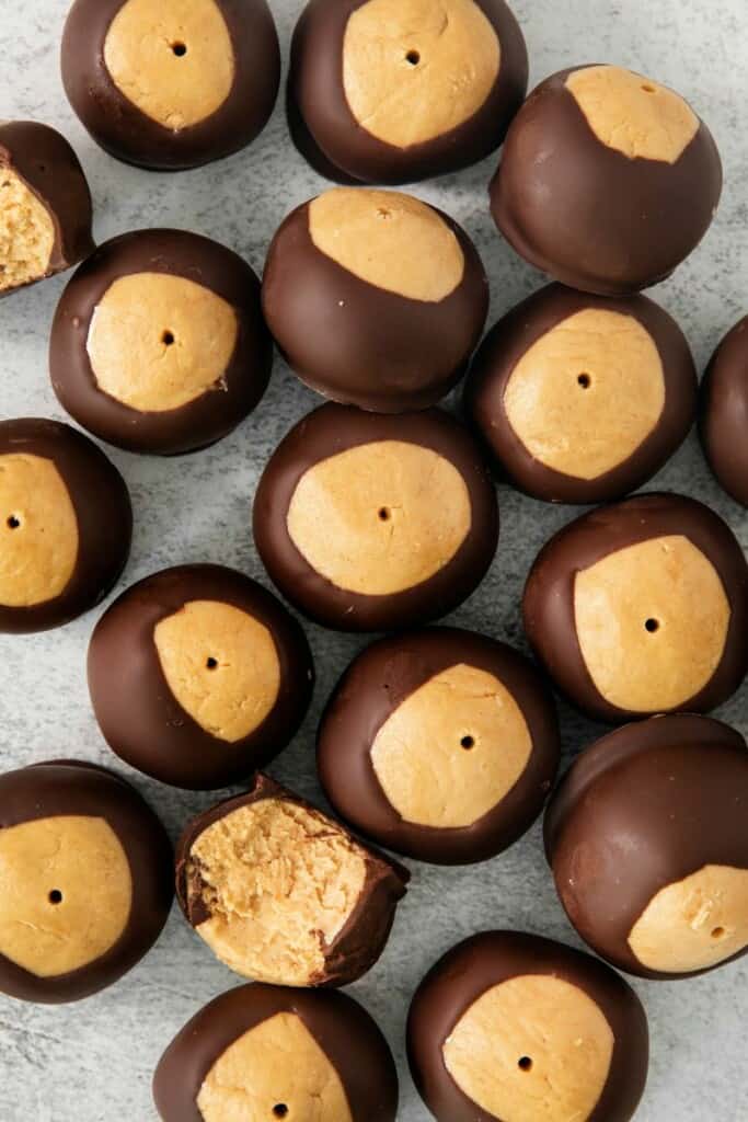 a sheet pan of buckeyes with chocolate and peanut butter