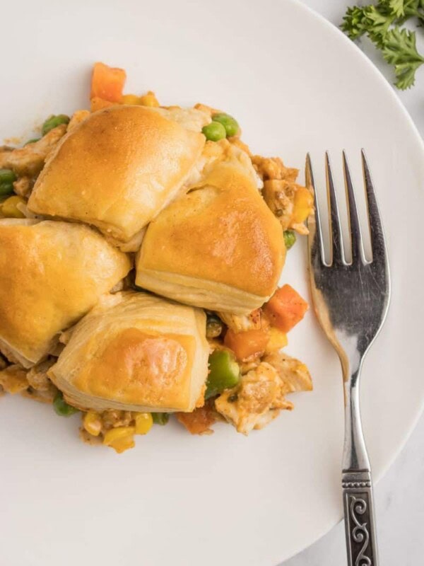 A plate of biscuit topped chicken pot pie with a fork.