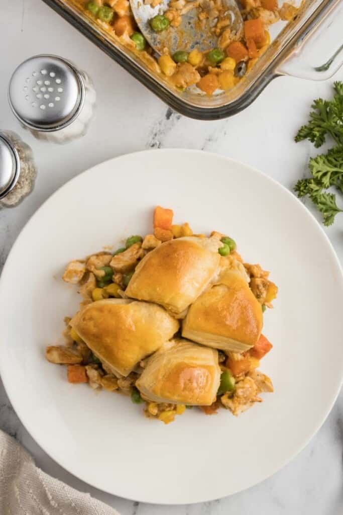 An overhead view of a single serving of biscuit topped chicken pot pie.